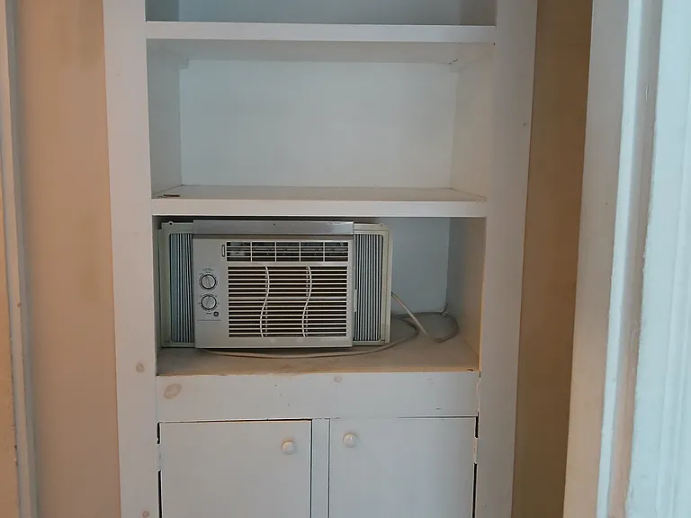 Linen closet in hall outside bathroom