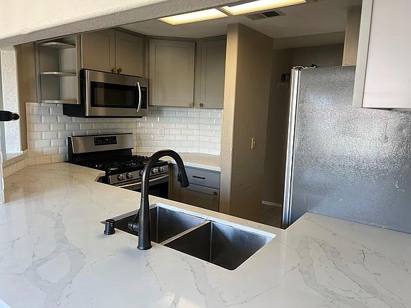 Kitchen with stainless steel appliances and quartz countertops