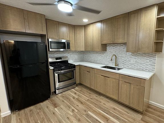 Kitchen area with gas stove and new appliances