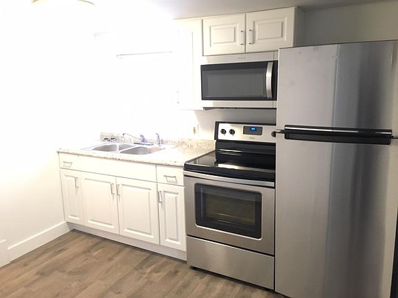 Kitchen includes electric oven/stove, fridge, & microwave
