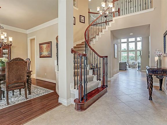 The front sweeping staircase leads you to the second level with elegance.
