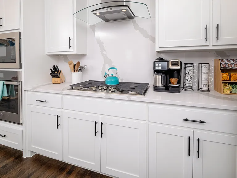 Fully stocked kitchen with coffee, tea kettle, and creamers available for use.
