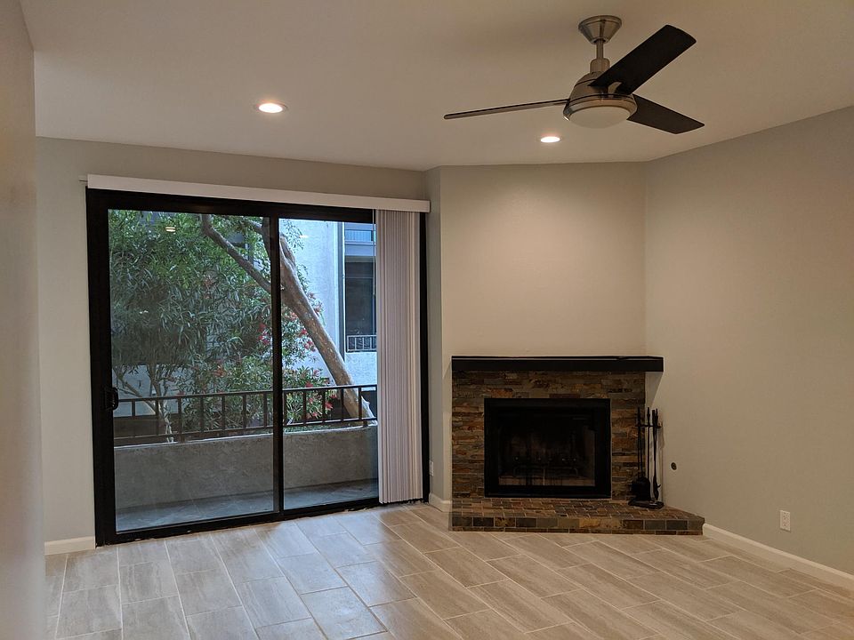 Newly renovated living room: LED recessed lighting, remote controlled fan, slate tile fireplace, slate tile balcony, double pane