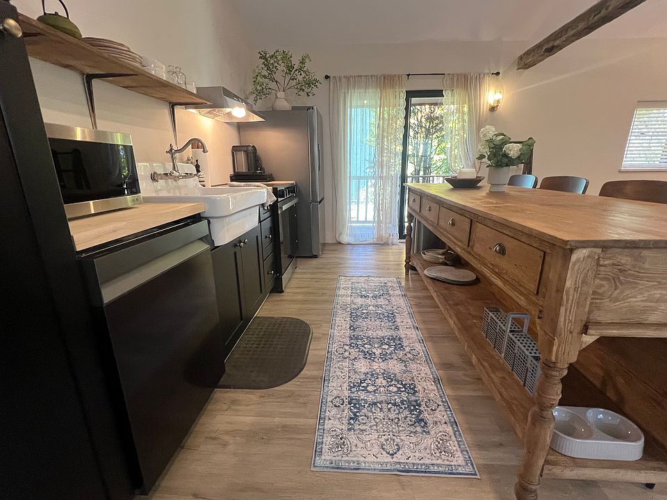 Kitchen with custom island, all new appliances and marble toe kicks!