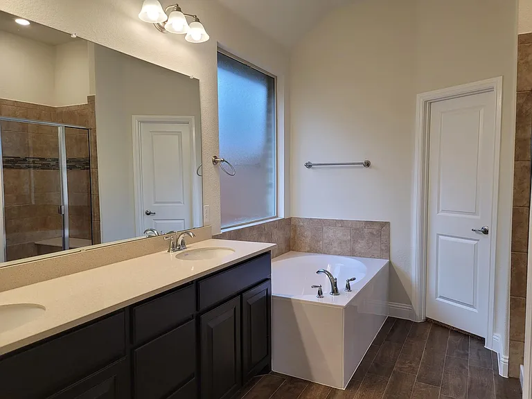 The master bath has separate tub and shower, dual sinks and large walk-in closet.