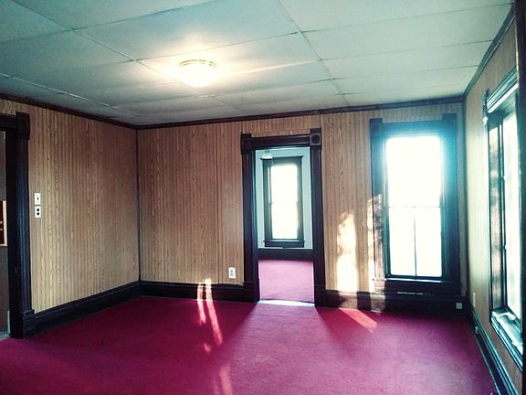 Largest living room, with the kitchen to the left where you see the door frame. This is a view from the glass doors, to the east, showing the living room and continuing into the first-floor bedroom/office space which can be closed off from the living roo