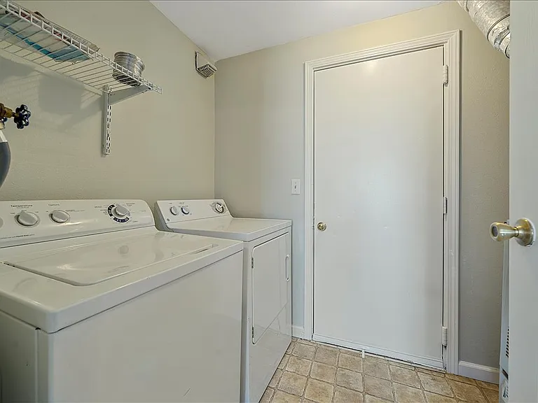 Main floor laundry room with a full size washer and dryer