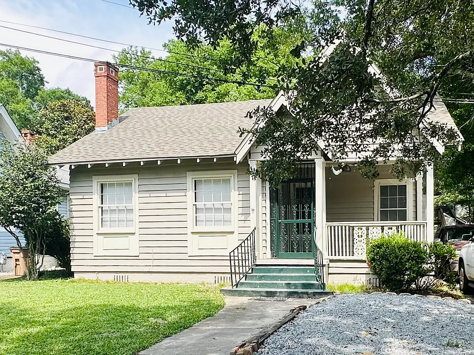 Front of the house, including the gravel parking and precious, large front sitting porch!