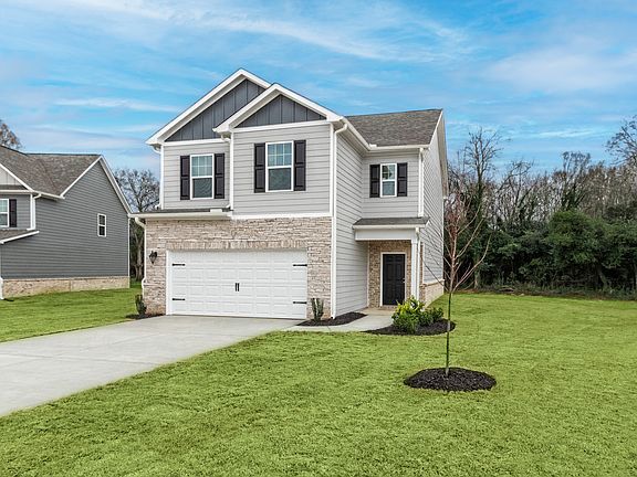 Beautiful exterior of the Burke floor plan with brick and stone.