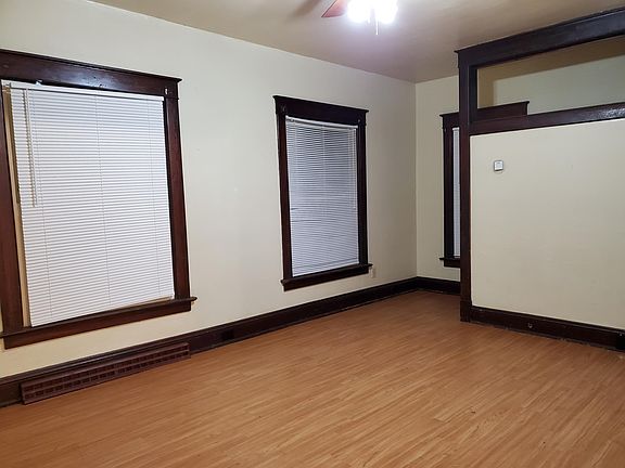 More Living rm with lots of bright energy windows, blinds and staircase to 2nd floor