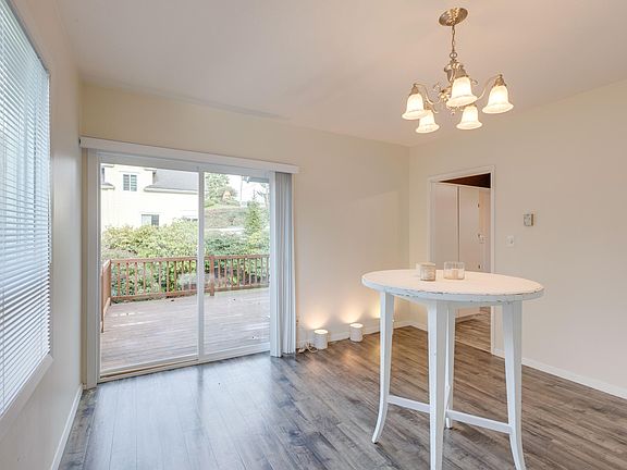 Sunny dining room with airy access to deck.