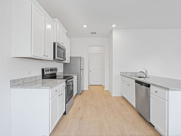 A chef-ready kitchen with granite countertops and stainless steel appliances