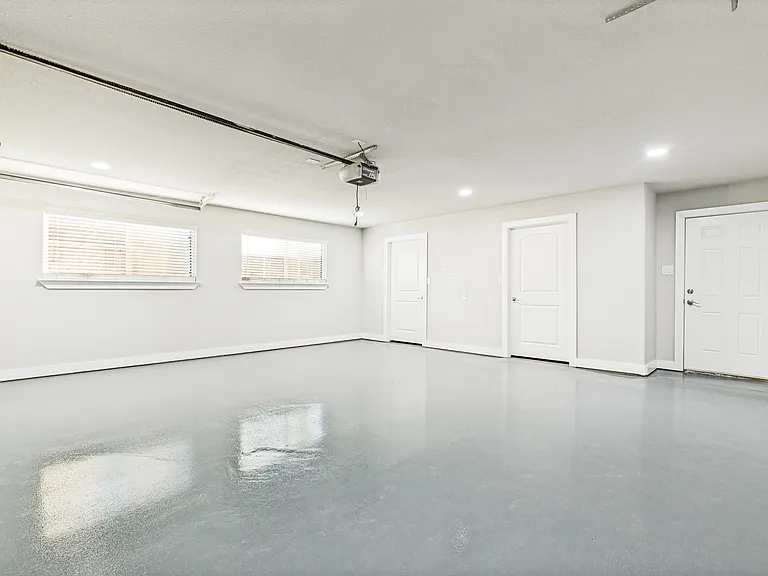 Completely finished out garage with epoxy flooring and large double door storage closet with access to covered back patio!