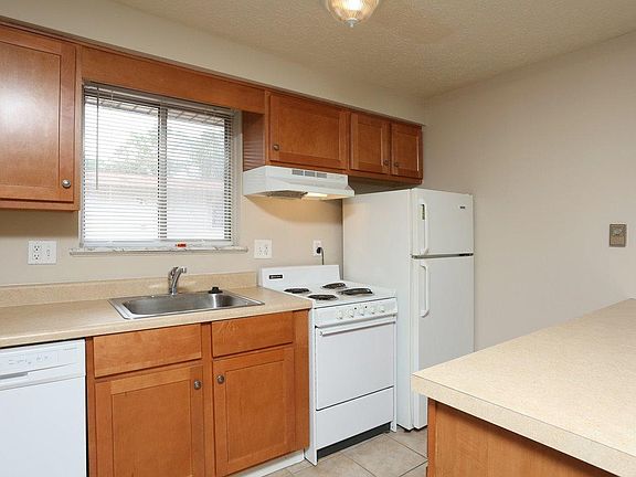 1 bedroom apartment kitchen with all white appliances