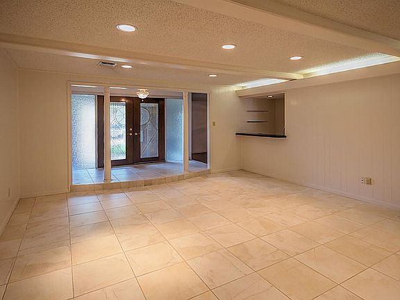 The raised, front entry hall is set off by twin columns and a crystal chandelier.