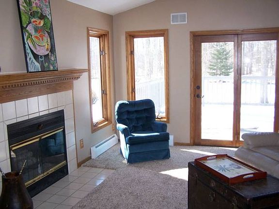 Living room offers a fireplace and door leading to the recently stained wood deck.