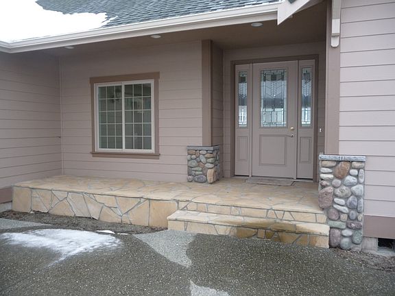 This entryway is designed with multi exterior treatments in order to make this home feel more like a