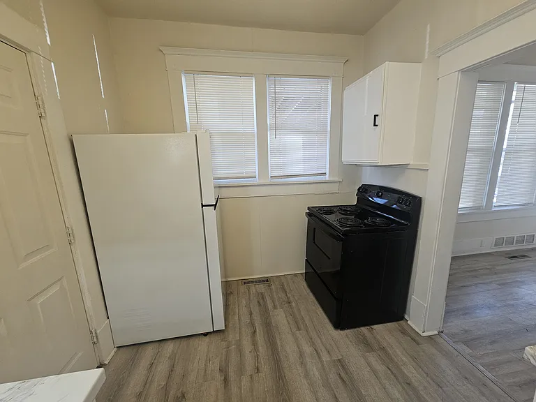 Kitchen includes stove and fridge.