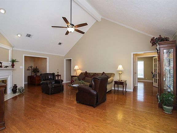 The spaciousness of this home continues into the vaulted-ceiling family room.