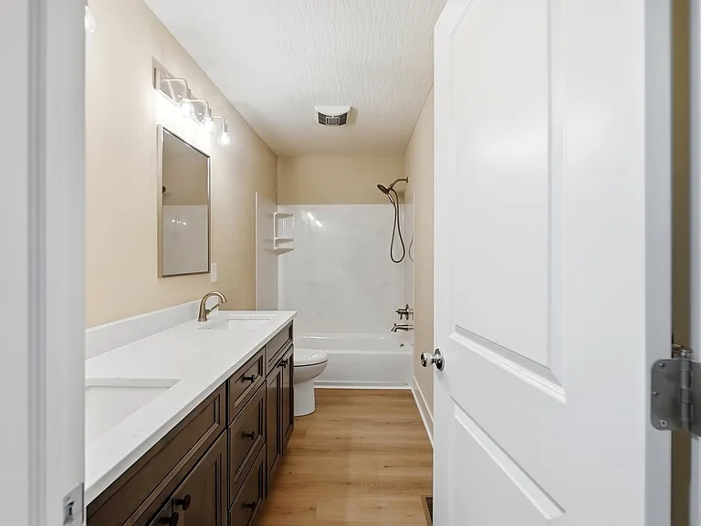 Second floor bathroom with tub and double vanties