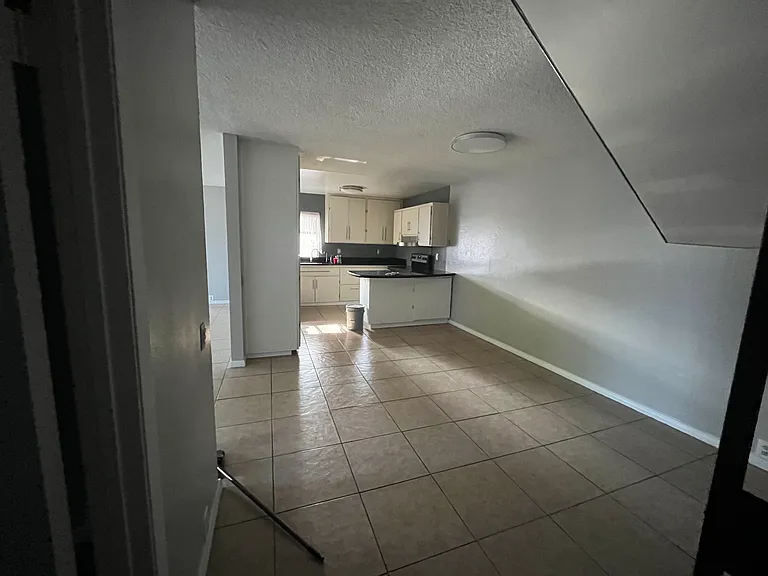 Kitchen and dining area from bottom of stairs