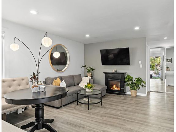 Charming open living and dining area, filled with natural light and cozy comfort.
