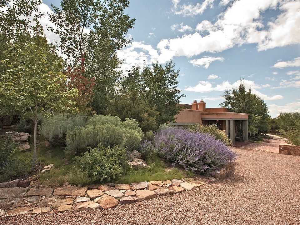 Nestled on the side of a hill north of downtown Santa Fe, this alluring property offers a rare combi