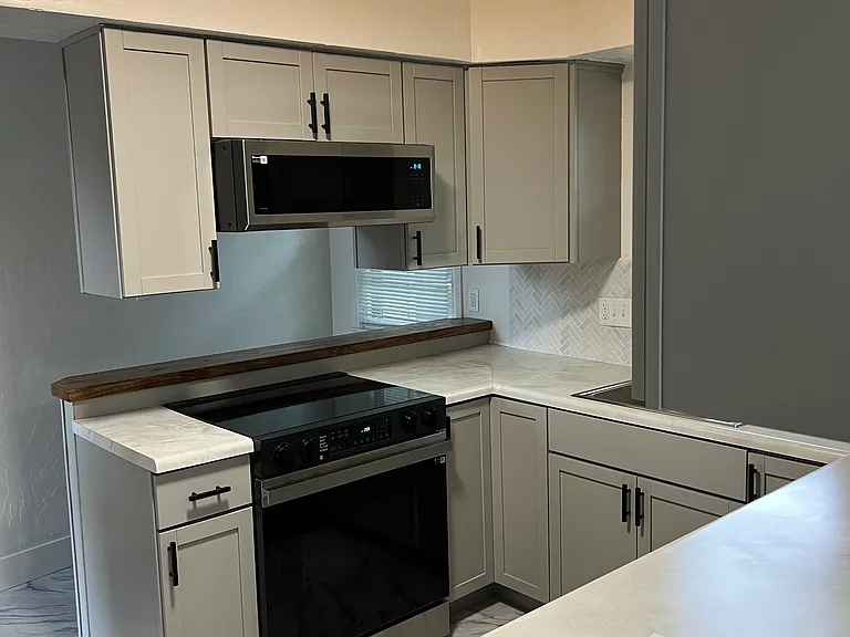 Kitchen view to garage with bar stool area