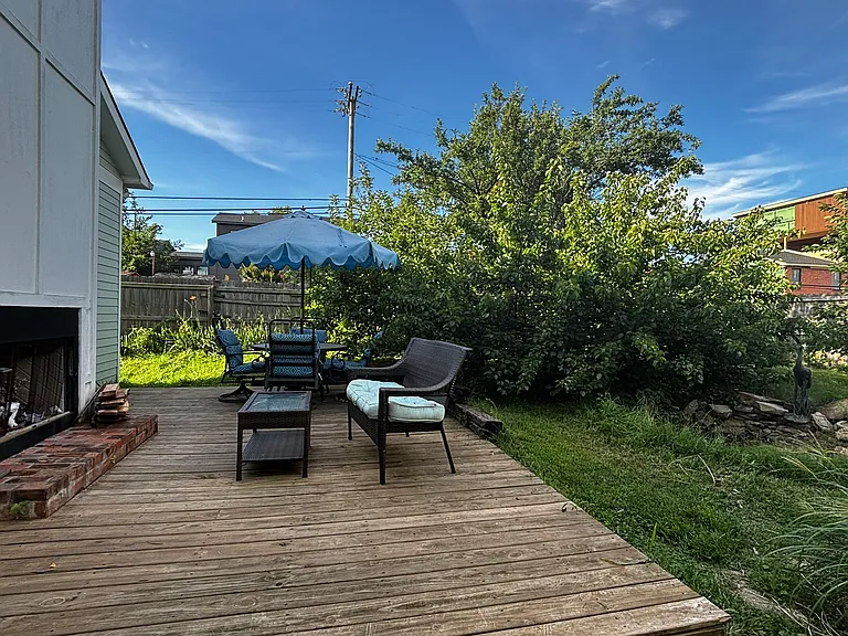 Back deck with wood-burning fireplace and fruit orchard.