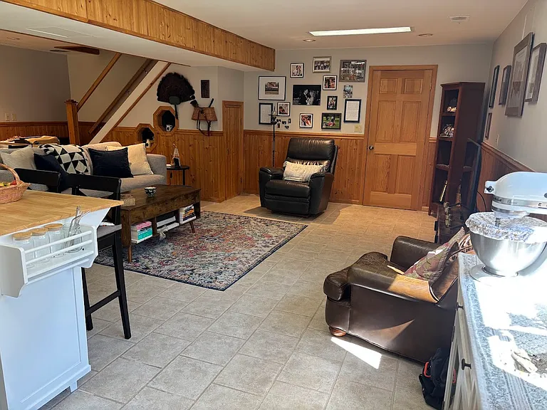 Livingroom with storage closet to the left of the easy chair