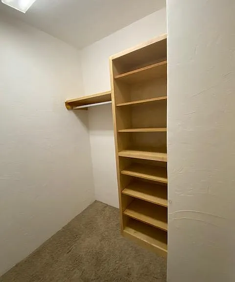 Walk in closet. Lots of shelving and hangar space!
