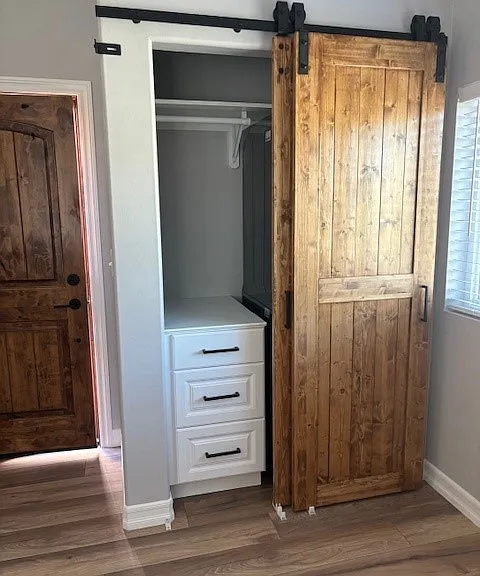 Other side of laundry closet: drawers and a large shelf above the dryer.