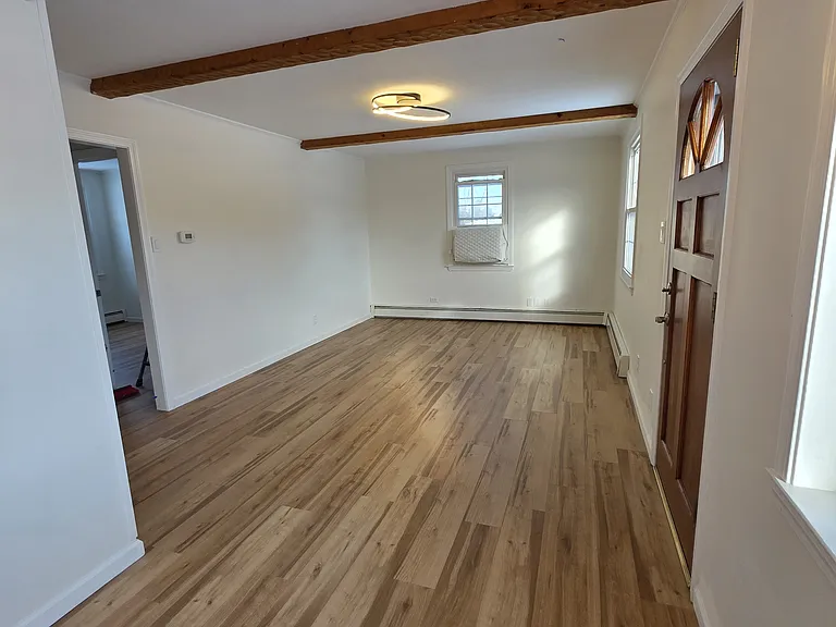 Dining and living area. New floors and fresh paint throughout.