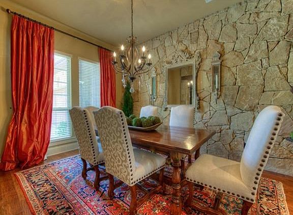 The formal dining room boasts a stone accent wall.
