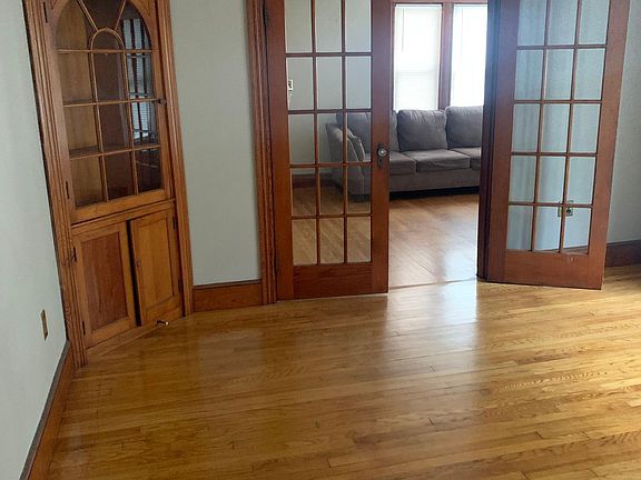 Dinning room with built in china cabinet and french doors into the livingroom.