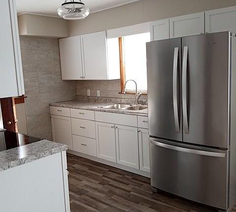 New cabinets, Sink and a 36" Stainless Steel Fridge.