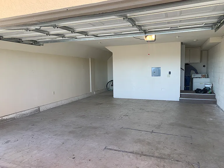 Large two car garage with extra storage and hook-ups for washer and dryer.