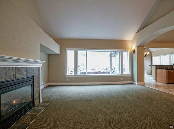 Living room with fireplace and vaulted ceilings