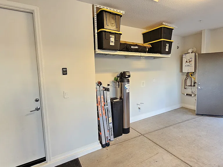 Garage, over-head shelves, service side door.
Water softener and Tankless water heater.
