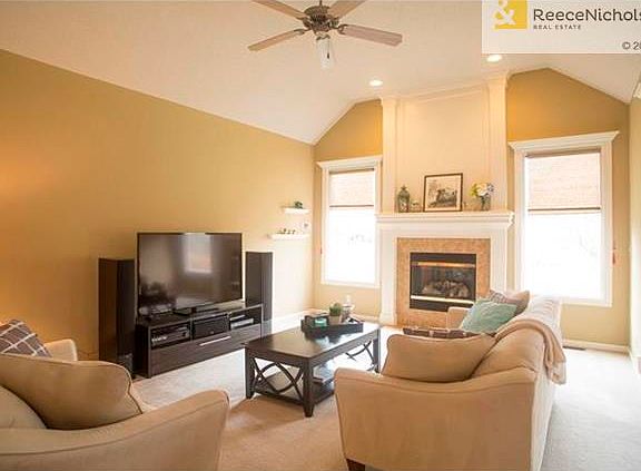 Great room with vaulted ceiling and grand gas fireplace.