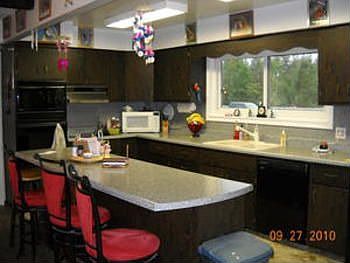 As you tour thru the home check out the spacious kitchen with bar counter area and the many cupboard