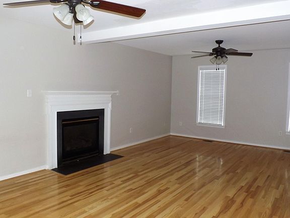 Large Family Room is Light and Bright with Gas Fireplace an Hardwood Floor.