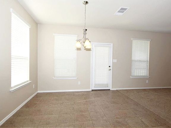 Dinette with door to back patio and back yard.