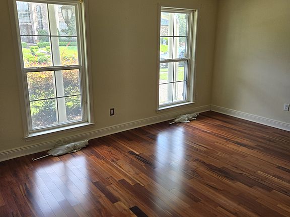 Hardwood living room and joining dining room floors.