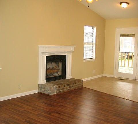 Living room with wood burning fireplace and new wood laminent
