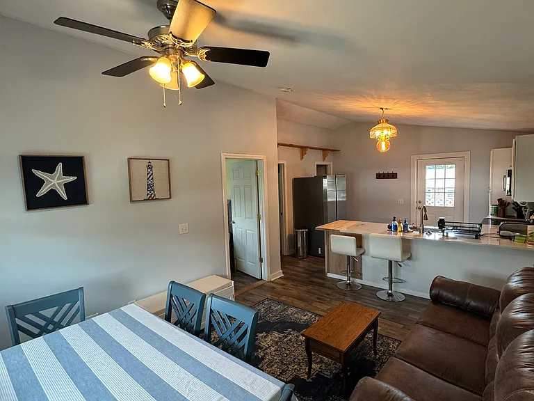 Dining room table, living room and couch.
