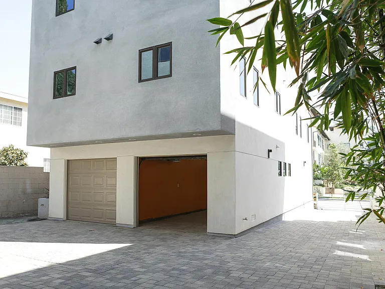 Driveway and Front Apartment Garage with Door Opened