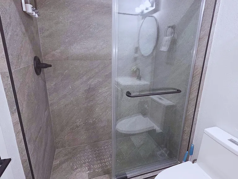 Contemporary bathroom with modern shower & spotless toilet