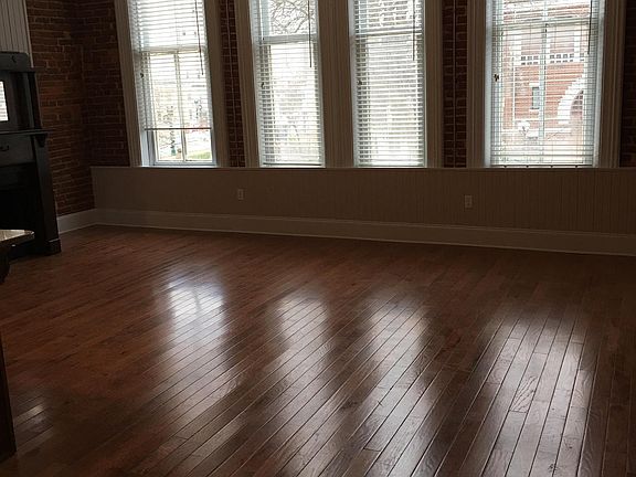 Living room with fireplace overlooking the courthouse. Real oak hardwood floors.