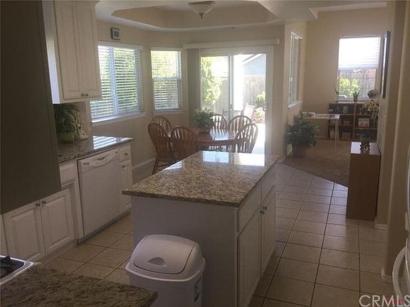 Renovated kitchen with granite counter tops and white cabinets.  Covered patio just outside the bright airy nook